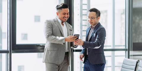 financial professional looking at phone with client