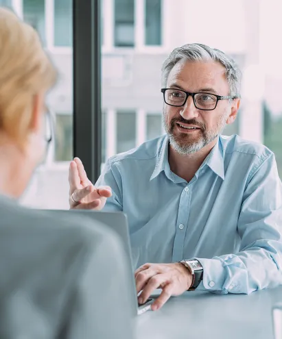 An elderly man talking to his advisor