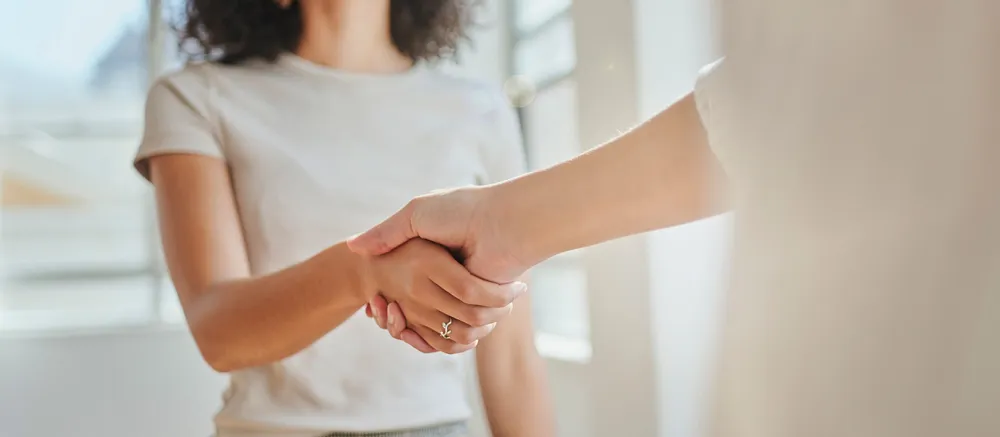 Two women shaking hands