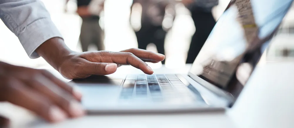Man working and typing on his laptop